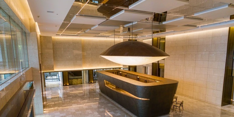 Saucer pendant above a hotel lobby desk Saucer pendant above a hotel lobby desk